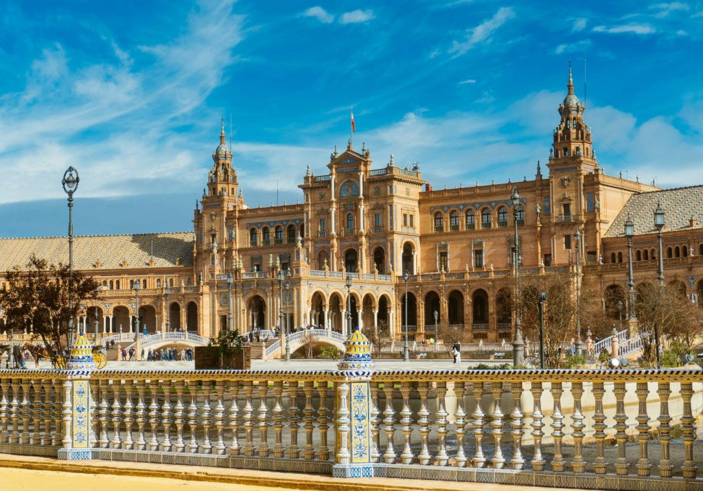 Grand historic building with ornate railings under blue sky