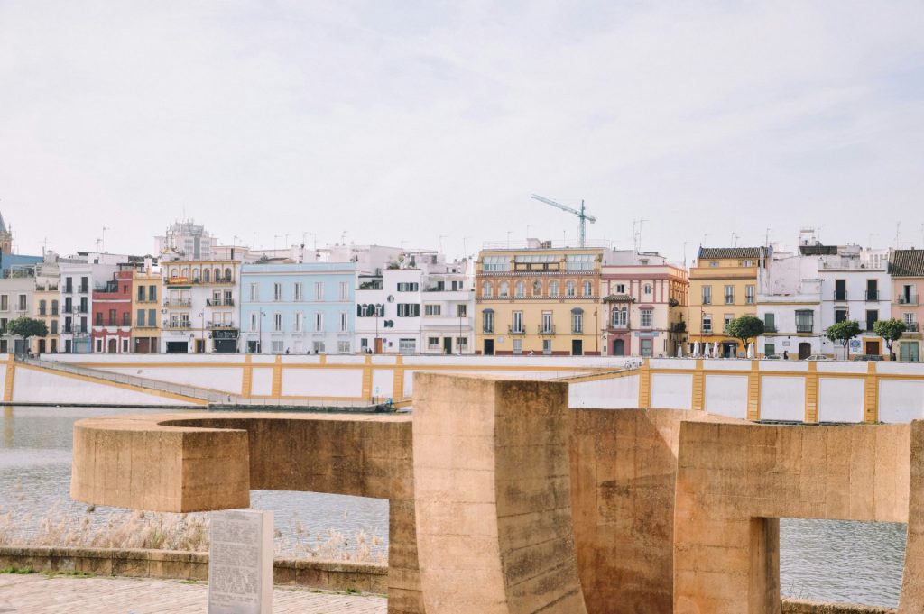a bridge over a body of water with buildings in the background